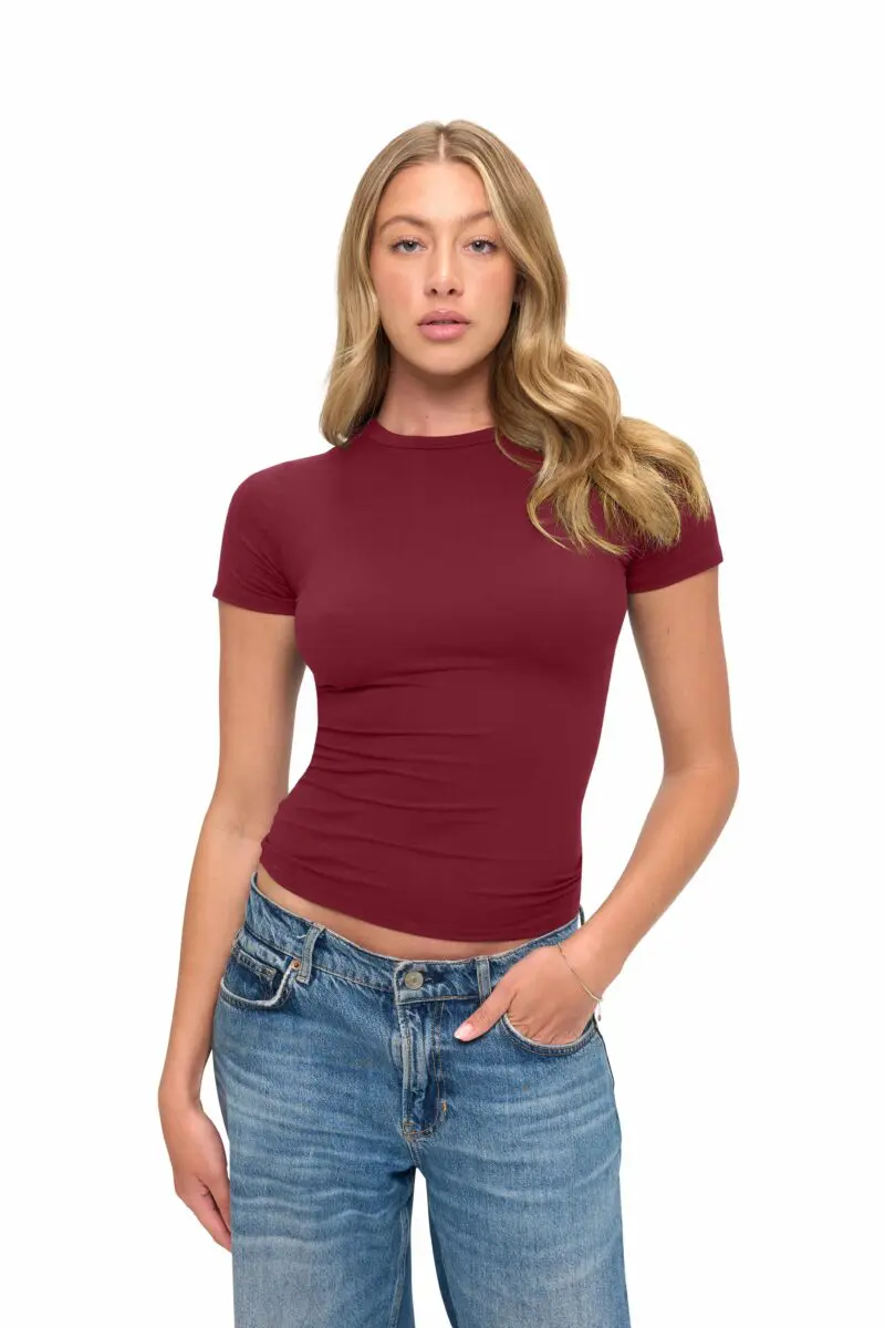 Wholesale women's burgundy short-sleeve fitted crew neck t-shirt paired with blue denim jeans