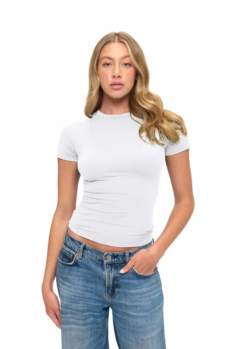 Wholesale women's white short-sleeve fitted t-shirt with crew neckline paired with blue denim jeans