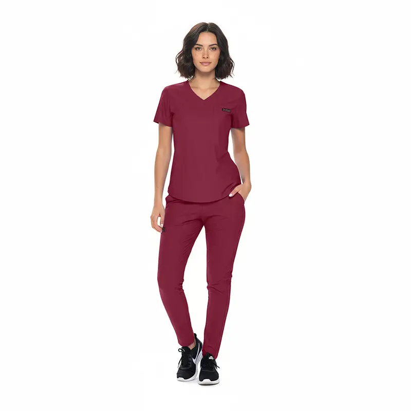 Wholesale women's burgundy v-neck scrub top and pants set with black sneakers